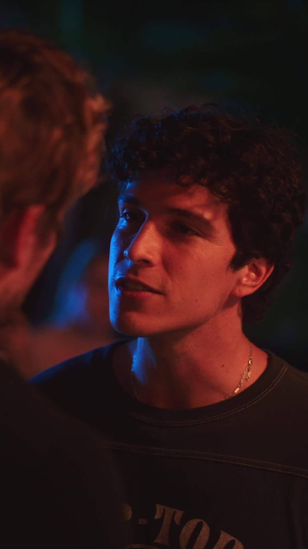 Strings Attached — a young man in colorful party lighting