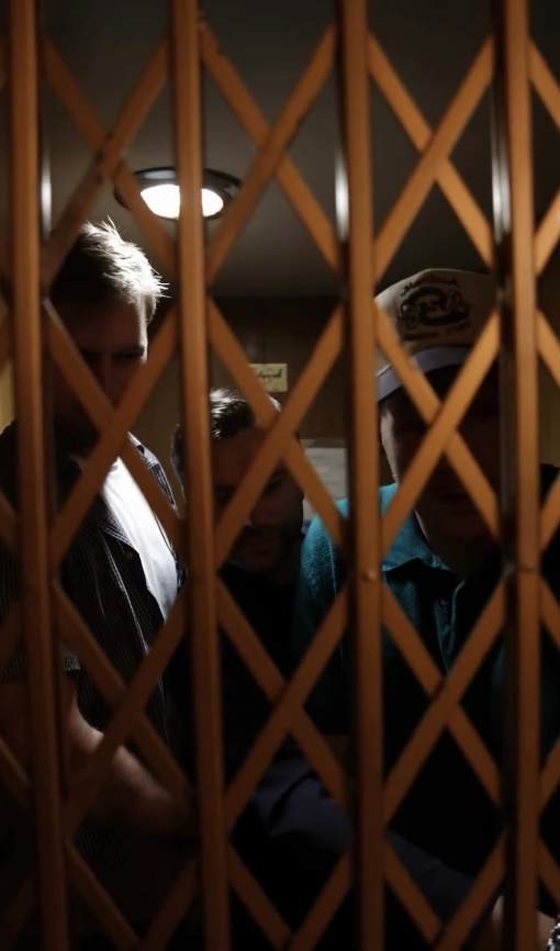 Selling Skylines — a group of people seen through a decorative gate